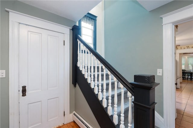 70 E Main St, Avon, NY 14414 - stairs with a baseboard radiator and tile patterned floors