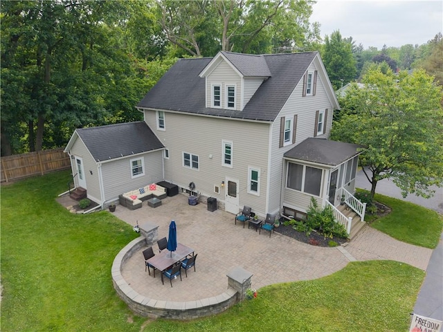 70 E Main St, Avon, NY 14414 - back of property featuring a sunroom, a patio area, and view of wooded area