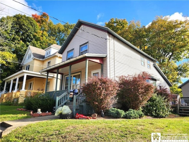 124 Bowen St, Jamestown, NY 14701 - view of side of property with covered porch and a lawn
