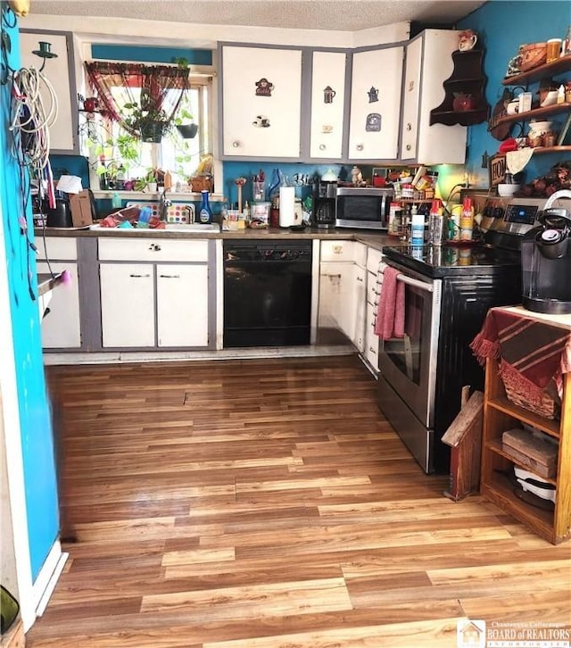 124 Bowen St, Jamestown, NY 14701 - kitchen featuring stainless steel appliances, white cabinets, light wood finished floors, and open shelves