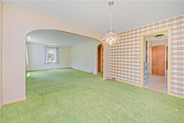 334 Woodcrest Rd, Greece, NY 14616 - carpeted spare room with arched walkways, a textured ceiling, and wallpapered walls