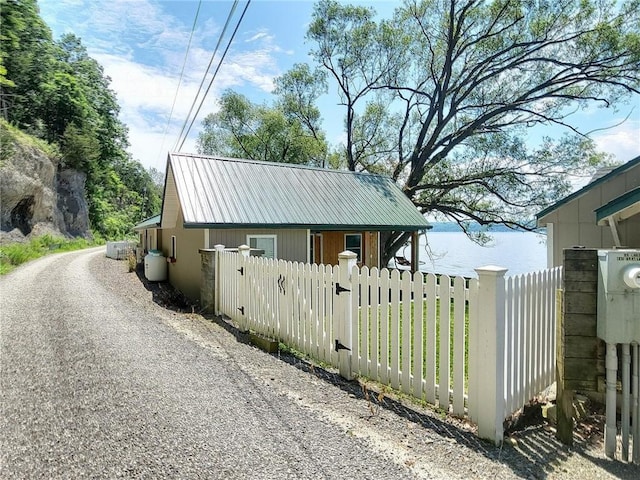 641 Fire Ln Unit 5, Genoa, NY 13081 - view of side of property featuring a metal roof and gravel driveway