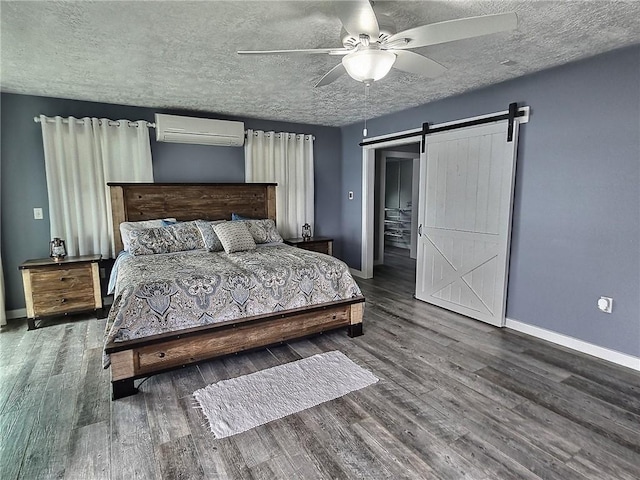 641 Fire Ln Unit 5, Genoa, NY 13081 - bedroom with a wall mounted AC, a barn door, wood finished floors, a textured ceiling, and a ceiling fan