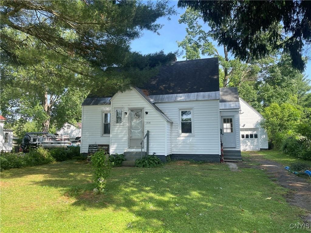 314 Mcrae St, Rome-Inside, NY 13440 - bungalow-style house featuring entry steps, a garage, and a front yard