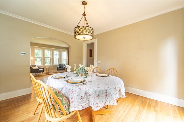 276 Susquehanna Rd, Brighton, NY 14618 - dining space with arched walkways, wood finished floors, and crown molding
