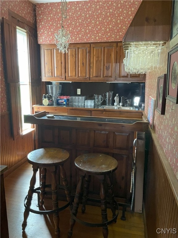 11159 State Route 34, Cato, NY 13033 - bar featuring wallpapered walls, light wood finished floors, and a chandelier