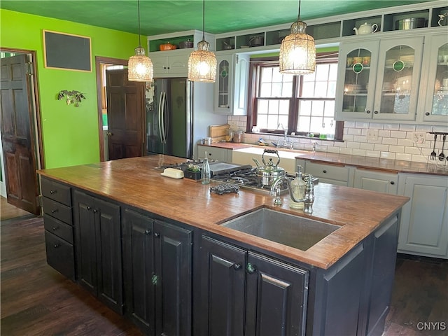 11159 State Route 34, Cato, NY 13033 - kitchen featuring freestanding refrigerator, a center island with sink, white cabinetry, and dark wood-style floors