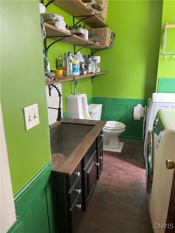 11159 State Route 34, Cato, NY 13033 - bathroom featuring washer and clothes dryer, wood finished floors, and a wainscoted wall