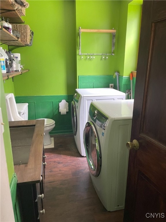 11159 State Route 34, Cato, NY 13033 - laundry area featuring washing machine and dryer, wainscoting, and dark wood-style flooring