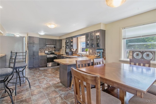4853 Enders Rd, Manlius, NY 13104 - kitchen with appliances with stainless steel finishes, gray cabinets, backsplash, glass insert cabinets, and a peninsula