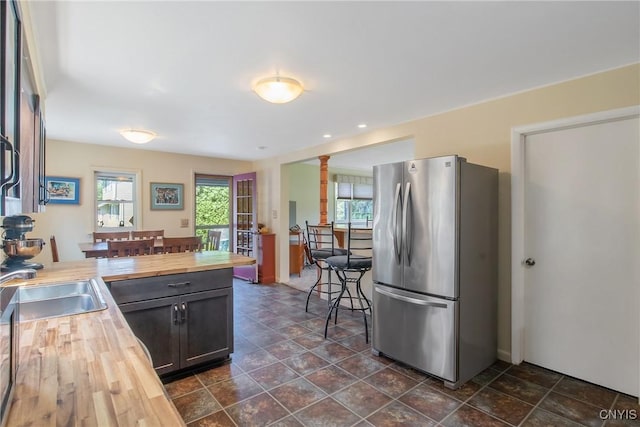 4853 Enders Rd, Manlius, NY 13104 - kitchen with wood counters, freestanding refrigerator, decorative columns, a peninsula, and recessed lighting