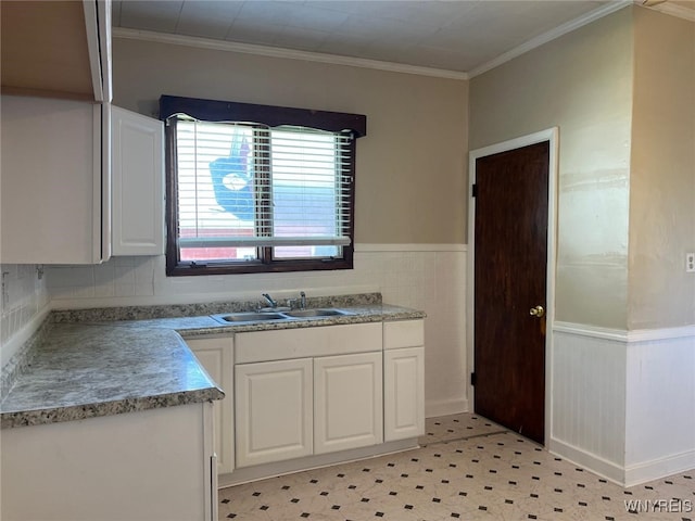 50 Ideal St, Buffalo, NY 14206 - kitchen with white cabinetry, a wainscoted wall, ornamental molding, light floors, and light countertops