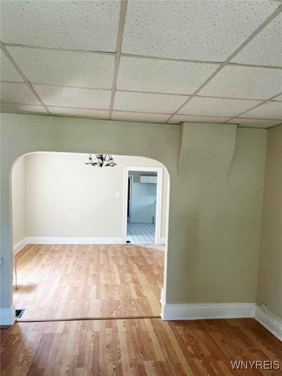 50 Ideal St, Buffalo, NY 14206 - unfurnished room featuring arched walkways, a paneled ceiling, wood finished floors, and a chandelier