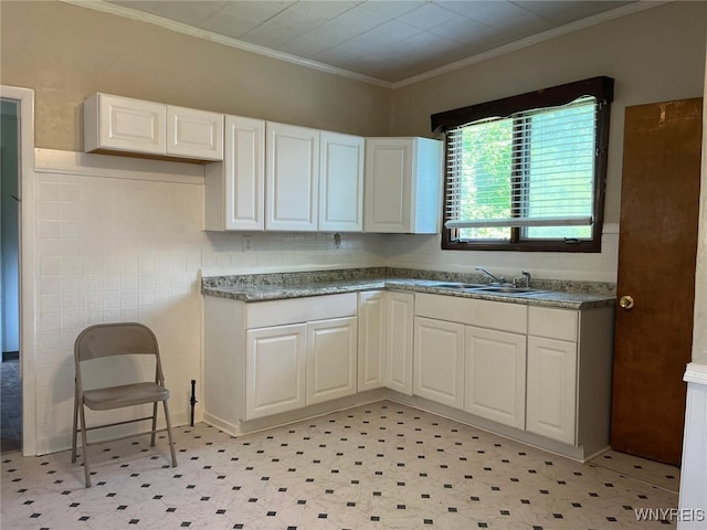 50 Ideal St, Buffalo, NY 14206 - kitchen featuring white cabinetry, light flooring, and ornamental molding