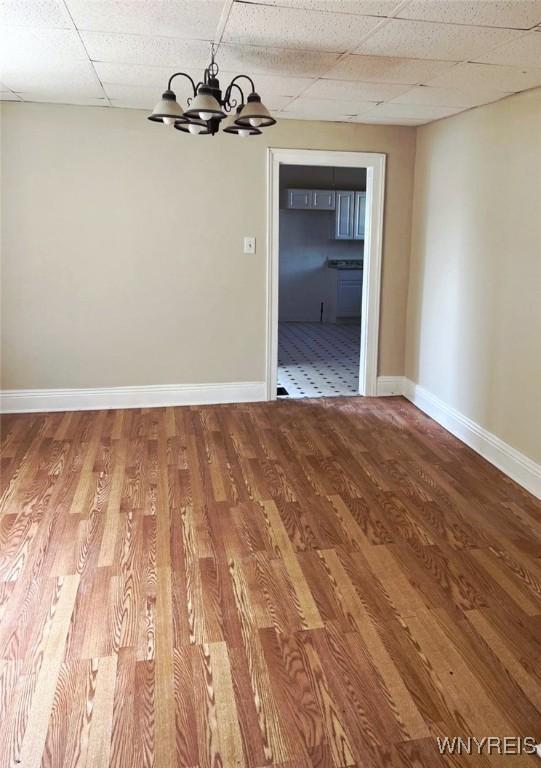 50 Ideal St, Buffalo, NY 14206 - spare room featuring a chandelier, a drop ceiling, and wood finished floors
