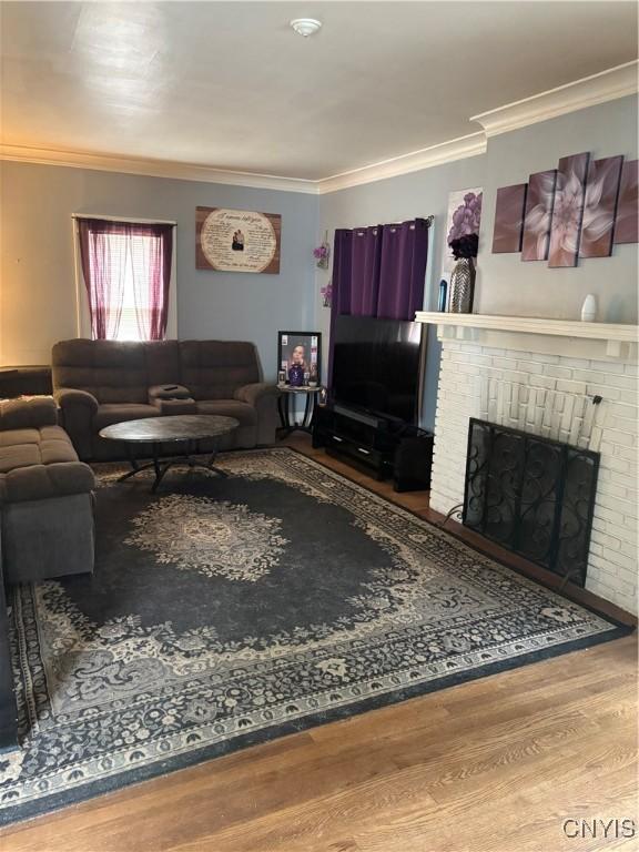 1905 S Geddes St, Syracuse, NY 13207 - living area with a fireplace, wood finished floors, and crown molding