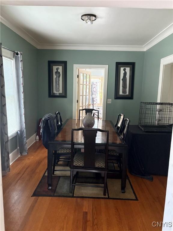 1905 S Geddes St, Syracuse, NY 13207 - dining space with healthy amount of natural light, wood finished floors, and ornamental molding