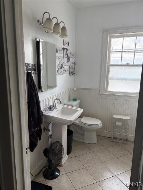1905 S Geddes St, Syracuse, NY 13207 - bathroom with a wainscoted wall and tile patterned flooring