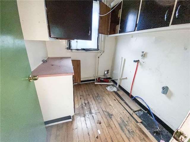 866 Smith St, Rochester, NY 14606 - laundry area with hardwood / wood-style floors and cabinet space