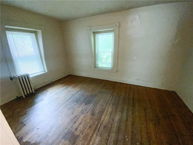 866 Smith St, Rochester, NY 14606 - empty room featuring radiator and wood finished floors