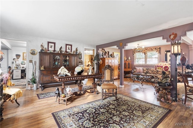 7438 Thunderbird Rd, Clay, NY 13088 - living room with a chandelier and wood finished floors