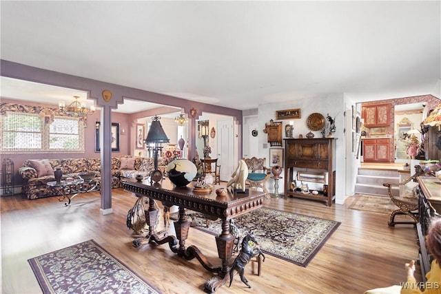 7438 Thunderbird Rd, Clay, NY 13088 - living room featuring wood finished floors and a chandelier