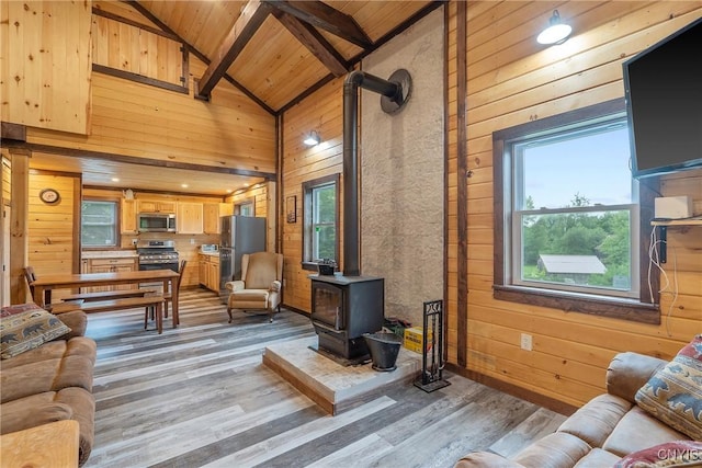 45 Fawn Lake Rd, Orwell, NY 13302 - living room featuring a wood stove, wood walls, light wood finished floors, a wooden ceiling with exposed beams, and high vaulted ceiling