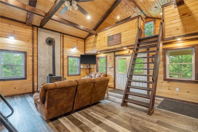 45 Fawn Lake Rd, Orwell, NY 13302 - living area featuring a wooden ceiling with exposed beams, wooden walls, a wood stove, wood finished floors, and stairway