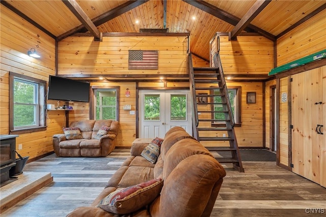 45 Fawn Lake Rd, Orwell, NY 13302 - living area with a wood stove, wood walls, a wood ceiling with exposed beams, healthy amount of natural light, and hardwood / wood-style flooring