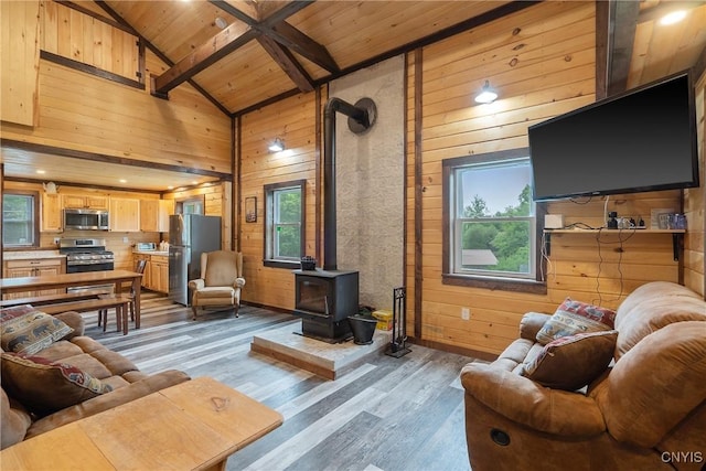 45 Fawn Lake Rd, Orwell, NY 13302 - living area with wood walls, a wooden ceiling with exposed beams, a wood stove, wood finished floors, and high vaulted ceiling