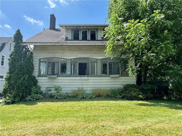 553 Denise Rd, Greece, NY 14616 - view of front of home with a chimney and a front lawn