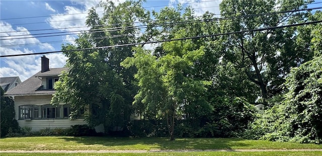 553 Denise Rd, Greece, NY 14616 - view of property exterior with a lawn and a chimney