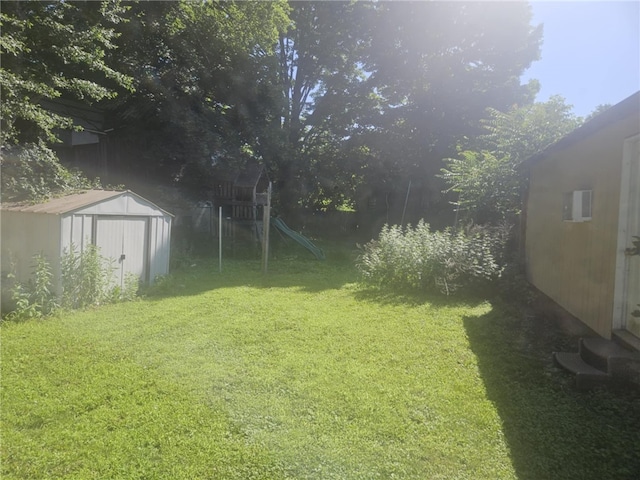 405 Balsam St, Elmira City, NY 14904 - view of grassy yard with a storage shed and a playground