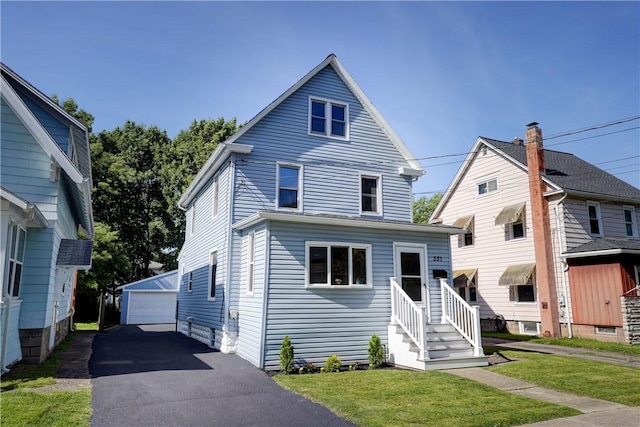 331 E Commercial St, East Rochester, NY 14445 - view of front facade featuring an outdoor structure, a garage, and a front yard