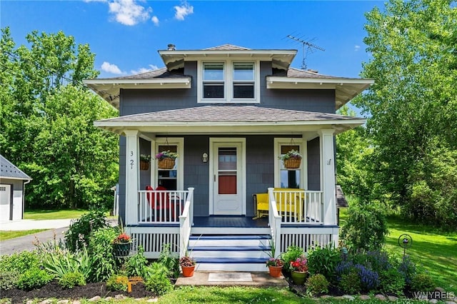 3121 Maple Rd, Wilson, NY 14108 - view of front of property with a shingled roof, a porch, and a garage