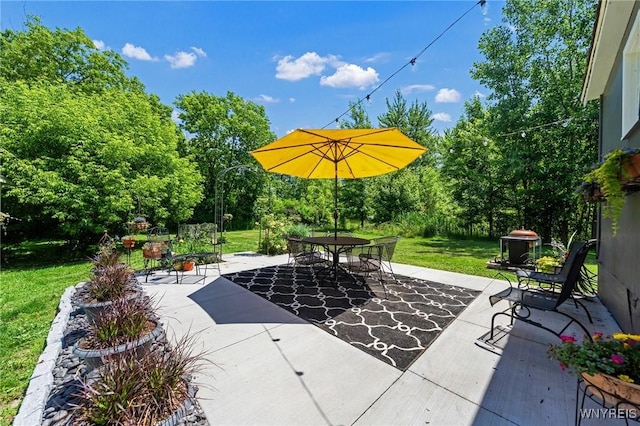 3121 Maple Rd, Wilson, NY 14108 - view of patio with outdoor dining area and view of wooded area