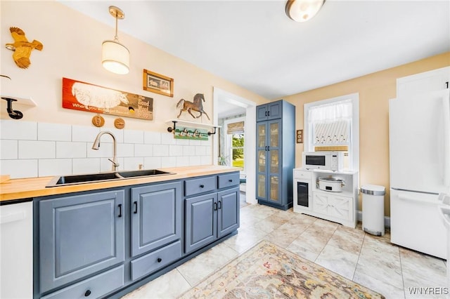 3121 Maple Rd, Wilson, NY 14108 - kitchen with white appliances, french doors, blue cabinets, and wood counters
