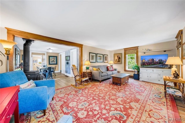 3121 Maple Rd, Wilson, NY 14108 - living area with a wood stove and light wood-type flooring
