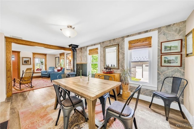 3121 Maple Rd, Wilson, NY 14108 - dining space with light wood finished floors and a wood stove