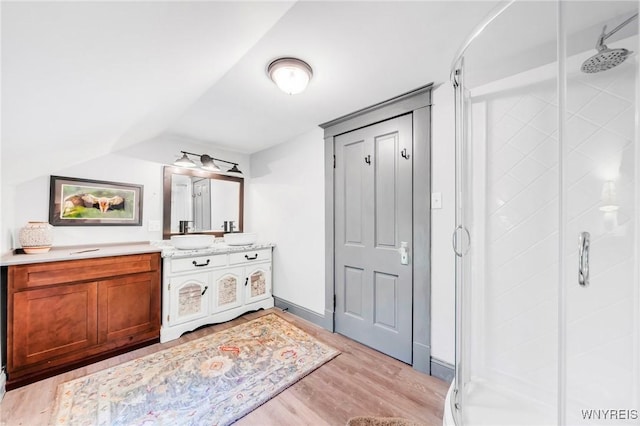 3121 Maple Rd, Wilson, NY 14108 - bathroom with a shower stall, vanity, wood finished floors, and vaulted ceiling