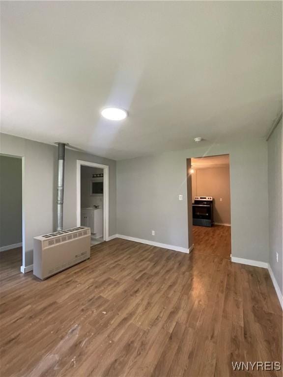 43 Union St, Collins, NY 14070 - unfurnished living room featuring wood finished floors and heating unit