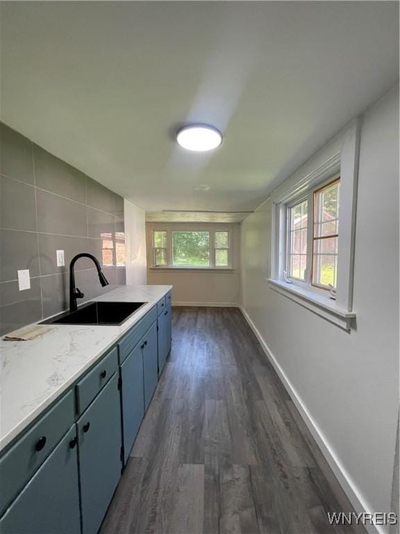 43 Union St, Collins, NY 14070 - kitchen featuring dark wood-style floors, tasteful backsplash, and blue cabinets