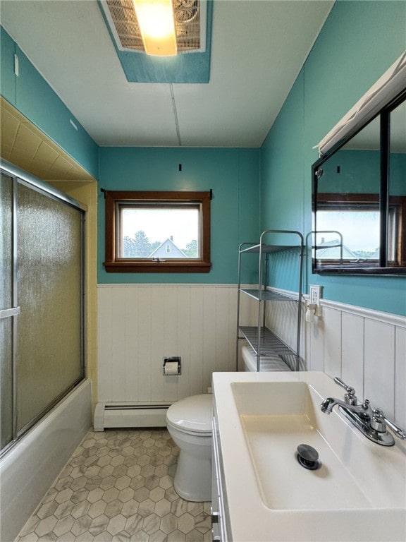 519 N Elk Ave, Kane Boro, PA 16735 - full bathroom featuring baseboard heating, a wainscoted wall, combined bath / shower with glass door, tile patterned floors, and vanity