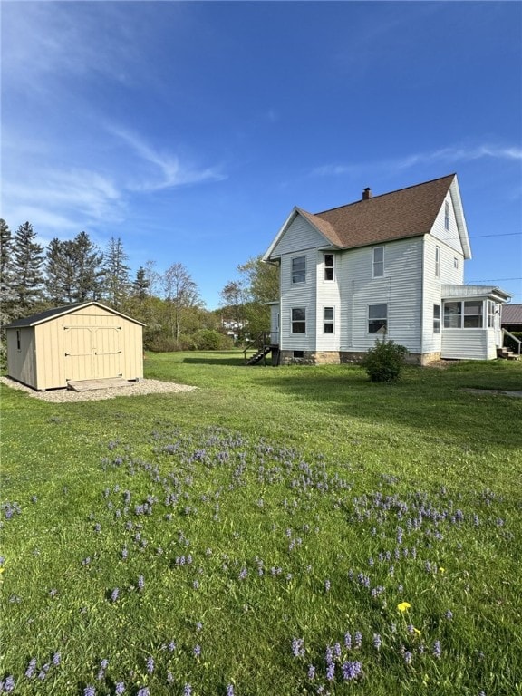 519 N Elk Ave, Kane Boro, PA 16735 - rear view of house with a shed and a yard