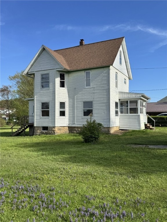 519 N Elk Ave, Kane Boro, PA 16735 - rear view of house featuring a chimney, a sunroom, and a yard