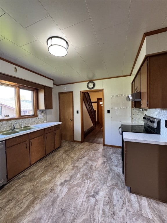 519 N Elk Ave, Kane Boro, PA 16735 - kitchen featuring under cabinet range hood, light countertops, stainless steel appliances, backsplash, and ornamental molding