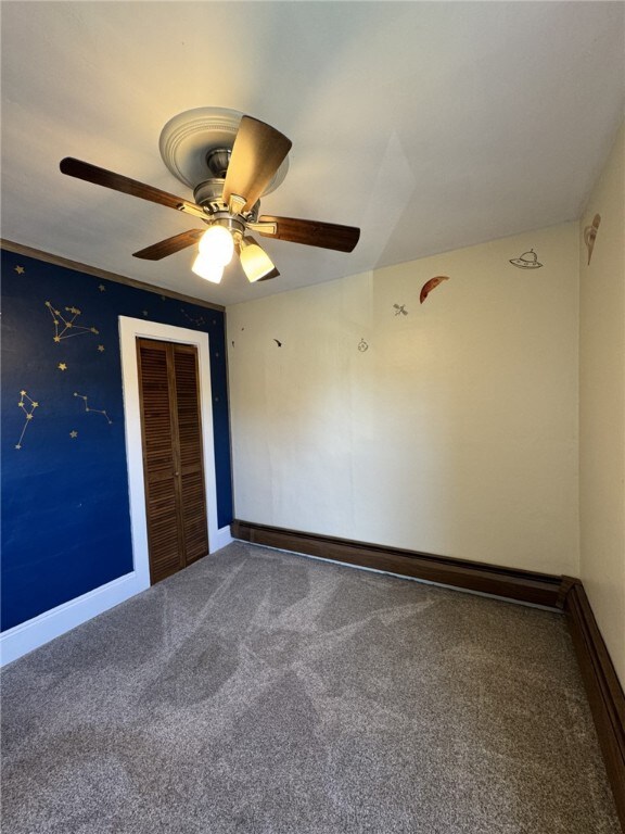 519 N Elk Ave, Kane Boro, PA 16735 - carpeted empty room featuring a ceiling fan and baseboards
