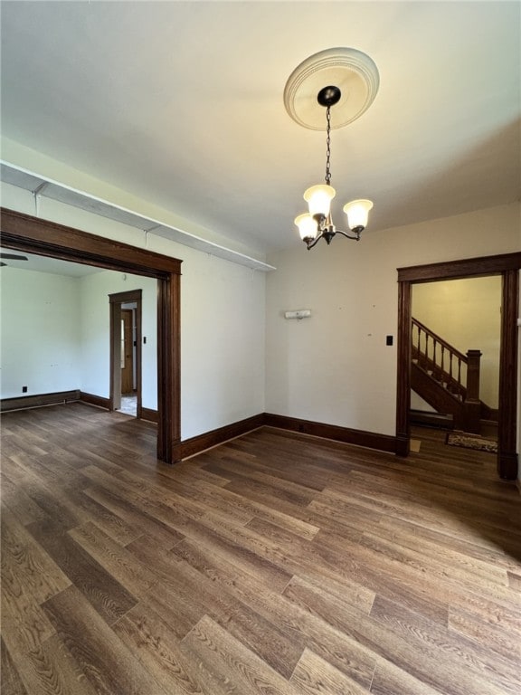519 N Elk Ave, Kane Boro, PA 16735 - unfurnished room with wood finished floors, a chandelier, and stairs