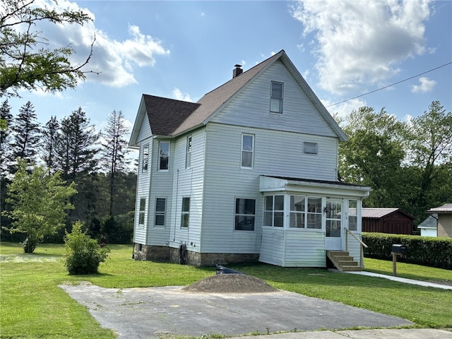 519 N Elk Ave, Kane Boro, PA 16735 - view of side of property featuring a sunroom, a lawn, a chimney, roof with shingles, and entry steps