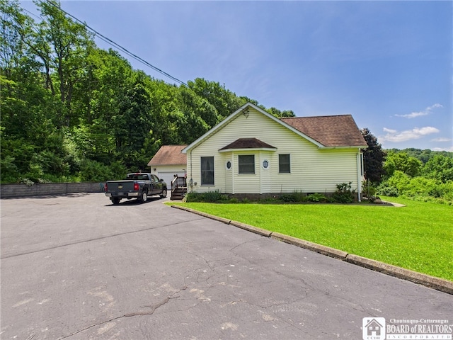 1501 Windfall Rd, Olean, NY 14760 - view of front facade with a front yard, roof with shingles, and a garage